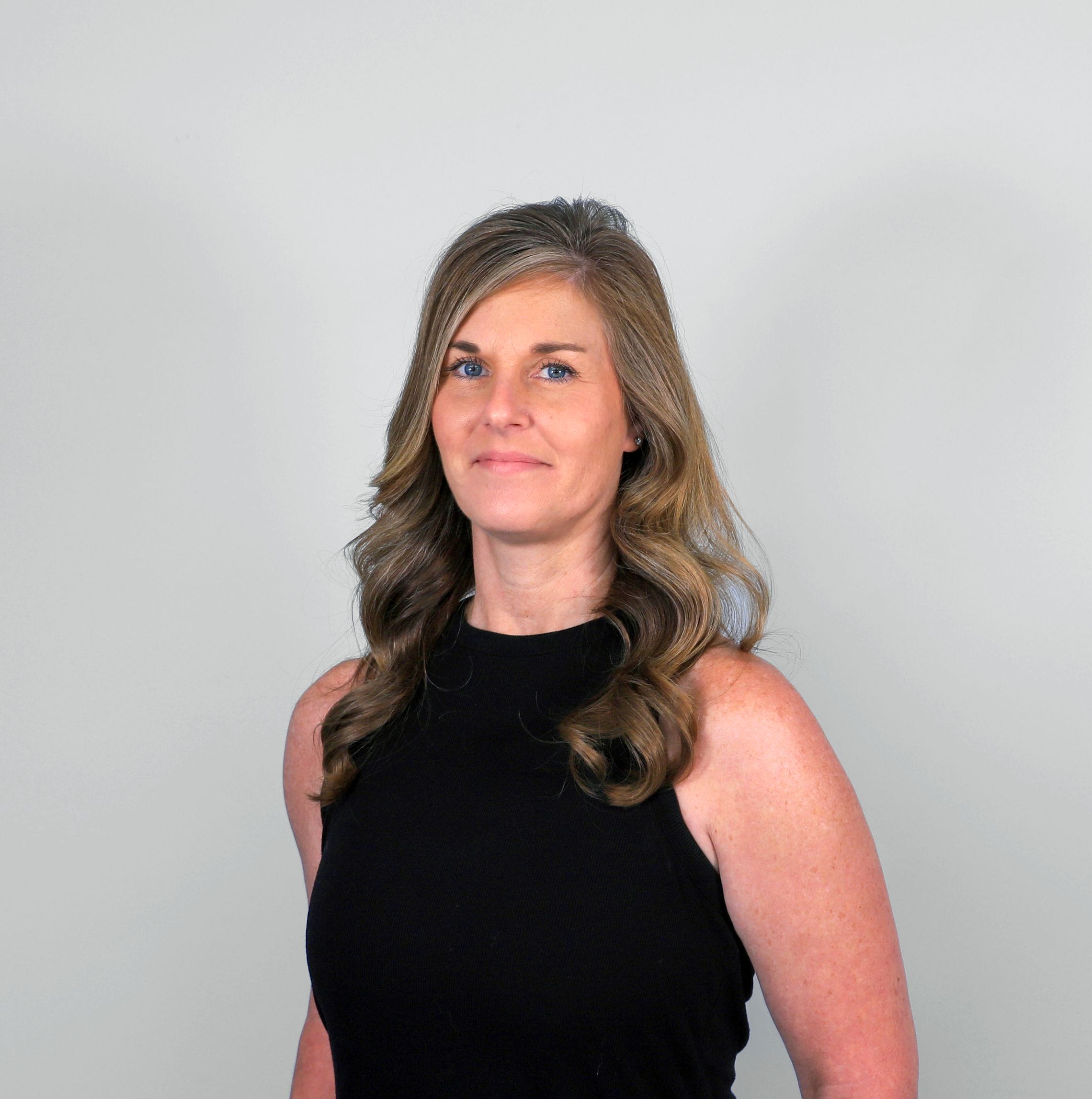 Woman with wavy hair, black top