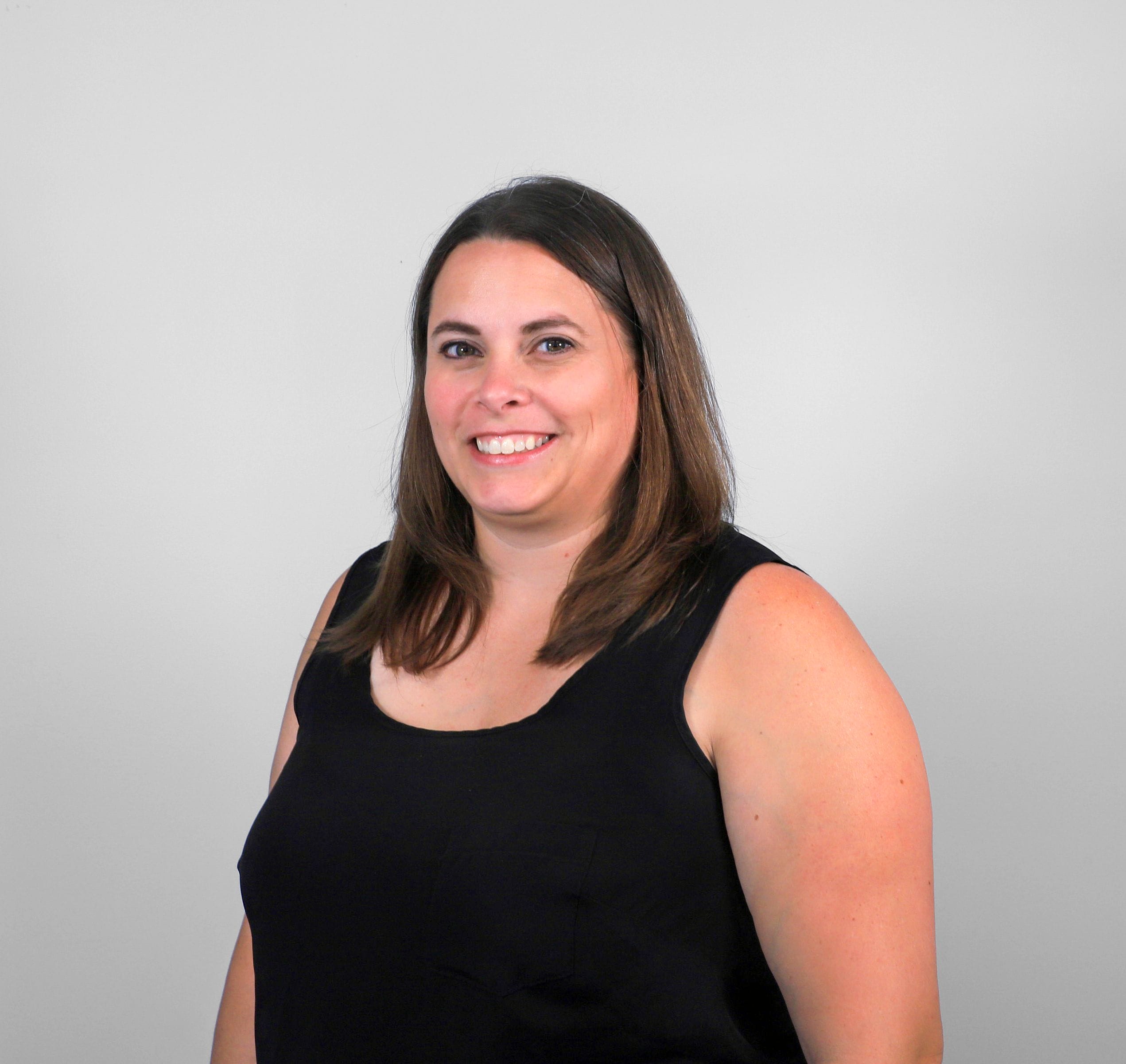 Woman in black tank top standing
